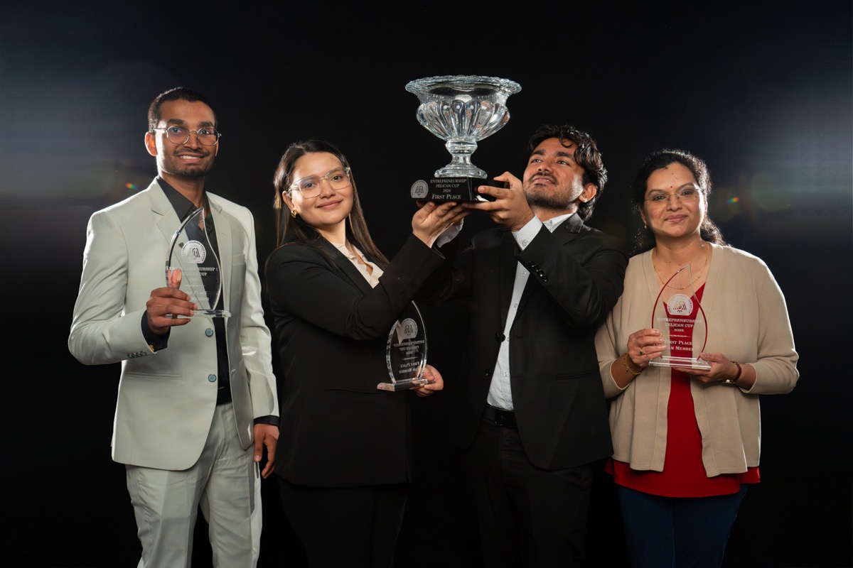 SocialBridge team standing with Pelican Cup award recipients on stage.